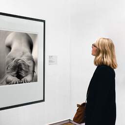 Art and collection photography Denis Olivier, Let Oneself Go, Bordeaux, France. October 2005. Ref-806 - Denis Olivier Art Photography, A woman contemplate a large original photographic art print in limited edition and signed in a black frame