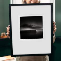 Art and collection photography Denis Olivier, Light Falling On Pier, Oléron Island, France. October 2011. Ref-1265 - Denis Olivier Photography, original 9 x 9 inches fine-art photograph print in limited edition and signed hold by a galerist woman