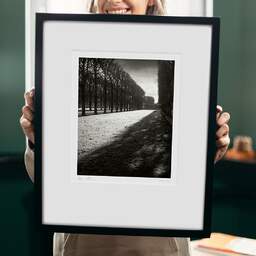 Art and collection photography Denis Olivier, Light Over Great Lawn, Luxembourg Garden, France. February 2022. Ref-11663 - Denis Olivier Photography, original 9 x 9 inches fine-art photograph print in limited edition and signed hold by a galerist woman