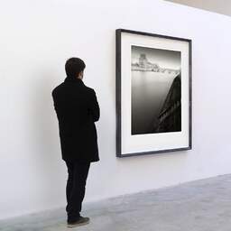 Art and collection photography Denis Olivier, Louvre And Pont Royal, Paris, France. February 2022. Ref-11649 - Denis Olivier Art Photography, A visitor contemplate a large original photographic art print in limited edition and signed in a black frame