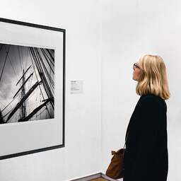 Art and collection photography Denis Olivier, Masts And Ropes, Etude 1, Belem Ship, France. June 2022. Ref-11551 - Denis Olivier Art Photography, A woman contemplate a large original photographic art print in limited edition and signed in a black frame