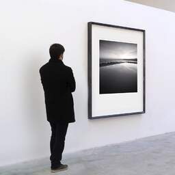 Art and collection photography Denis Olivier, Mediterranean Pool, Varazze, Italy. November 2011. Ref-11568 - Denis Olivier Art Photography, A visitor contemplate a large original photographic art print in limited edition and signed in a black frame