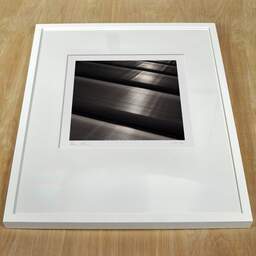 Art and collection photography Denis Olivier, Metallic, Poitiers, France. June 1990. Ref-919 - Denis Olivier Art Photography, white frame on a wooden table