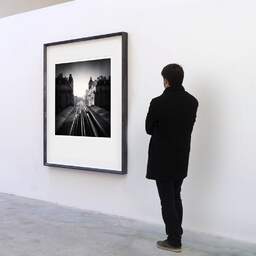 Art and collection photography Denis Olivier, Metro Line 6, Passy Station, Paris, France. February 2022. Ref-11526 - Denis Olivier Art Photography, A visitor contemplate a large original photographic art print in limited edition and signed in a black frame