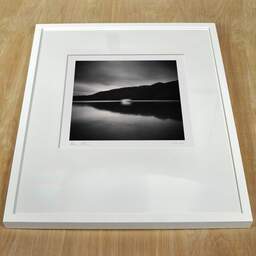 Art and collection photography Denis Olivier, Moving Boat, Lake Okataina, New Zealand. July 2018. Ref-1318 - Denis Olivier Art Photography, white frame on a wooden table