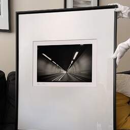 Art and collection photography Denis Olivier, Moving In A Tunnel, Highway A83, France. August 2020. Ref-1391 - Denis Olivier Photography, large original 9 x 9 inches fine-art photograph print in limited edition and signed hold by a galerist woman
