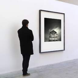 Art and collection photography Denis Olivier, Old Factory, Bassens, France. August 2006. Ref-1021 - Denis Olivier Art Photography, A visitor contemplate a large original photographic art print in limited edition and signed in a black frame