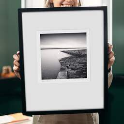 Art and collection photography Denis Olivier, Old Ramp, Chanonry Point, Scotland. August 2022. Ref-11578 - Denis Olivier Photography, original 9 x 9 inches fine-art photograph print in limited edition and signed hold by a galerist woman