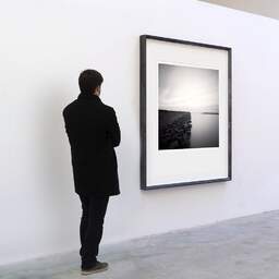 Art and collection photography Denis Olivier, Oostvaardersdijk, Etude 2, Lelystad, Flevoland, Netherlands. April 2015. Ref-11564 - Denis Olivier Art Photography, A visitor contemplate a large original photographic art print in limited edition and signed in a black frame