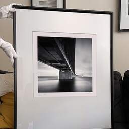 Art and collection photography Denis Olivier, Øresund Bridge, Etude 2, Malmö, Sweden. October 2008. Ref-11512 - Denis Olivier Photography, large original 9 x 9 inches fine-art photograph print in limited edition and signed hold by a galerist woman