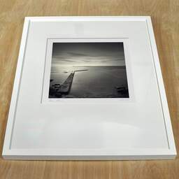 Art and collection photography Denis Olivier, Piers, Keiss Harbour, Scotland. April 2006. Ref-1054 - Denis Olivier Photography, white frame on a wooden table