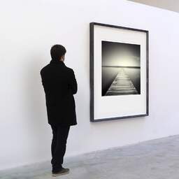 Art and collection photography Denis Olivier, Plank Walk, Lake Cazaux, France. July 2006. Ref-1008 - Denis Olivier Art Photography, A visitor contemplate a large original photographic art print in limited edition and signed in a black frame