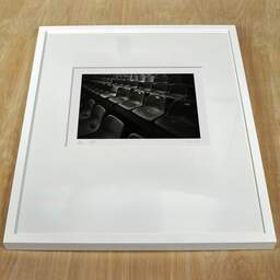 Art and collection photography Denis Olivier, Plastic Seats, Royan, France. August 2021. Ref-11628 - Denis Olivier Photography, white frame on a wooden table