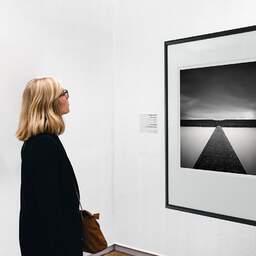 Art and collection photography Denis Olivier, Polder Line, Netherlands, Netherlands. April 2015. Ref-1310 - Denis Olivier Art Photography, A woman contemplate a large original photographic art print in limited edition and signed in a black frame