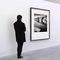 Art and collection photography Denis Olivier, Pont-Neuf Bridge, Etude 2, Toulouse, France. June 2021. Ref-11567 - Denis Olivier Art Photography, A visitor contemplate a large original photographic art print in limited edition and signed in a black frame