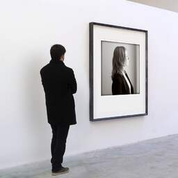 Art and collection photography Denis Olivier, Precious Times, Royan, France. July 2005. Ref-696 - Denis Olivier Art Photography, A visitor contemplate a large original photographic art print in limited edition and signed in a black frame