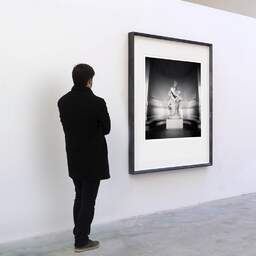 Art and collection photography Denis Olivier, Protection And Future Statue, Palais Galliera, Paris, France. February 2022. Ref-11530 - Denis Olivier Art Photography, A visitor contemplate a large original photographic art print in limited edition and signed in a black frame