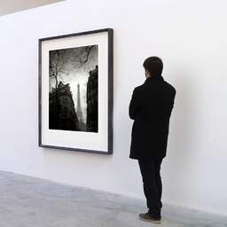Art and collection photography Denis Olivier, Rue De Monttessuy, Paris, France. February 2023. Ref-11669 - Denis Olivier Photography, A visitor contemplate a large original photographic art print in limited edition and signed in a black frame