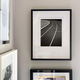 Art and collection photography Denis Olivier, Running Track, Etude 2, Leo Lagrange Stadium, Saint-Nazaire, France. November 2022. Ref-11644 - Denis Olivier Photography, original fine-art photograph signed in limited edition in a black wooden frame with other images hung on the wall
