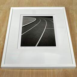 Art and collection photography Denis Olivier, Running Track, Etude 2, Leo Lagrange Stadium, Saint-Nazaire, France. November 2022. Ref-11644 - Denis Olivier Photography, white frame on a wooden table