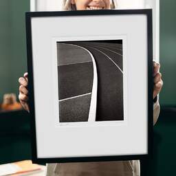 Art and collection photography Denis Olivier, Running Track, Leo Lagrange Stadium, Saint-Nazaire, France. November 2022. Ref-11621 - Denis Olivier Photography, original 9 x 9 inches fine-art photograph print in limited edition and signed hold by a galerist woman