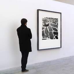 Art and collection photography Denis Olivier, Dali's Terrace, Cadaqués, Spain. September 2003. Ref-457 - Denis Olivier Art Photography, A visitor contemplate a large original photographic art print in limited edition and signed in a black frame