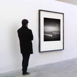 Art and collection photography Denis Olivier, Sand-Drift Fences, Koksijde Bad, Belgium. October 2008. Ref-1217 - Denis Olivier Art Photography, A visitor contemplate a large original photographic art print in limited edition and signed in a black frame