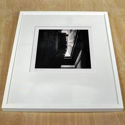 Art and collection photography Denis Olivier, Secret Door Alley, Talence, France. April 2021. Ref-1412 - Denis Olivier Art Photography, white frame on a wooden table