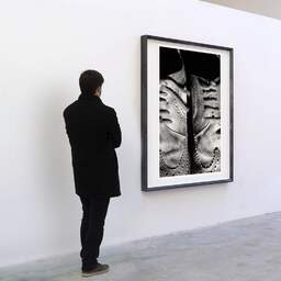 Art and collection photography Denis Olivier, Shoes, Poitiers, France. December 1990. Ref-94 - Denis Olivier Art Photography, A visitor contemplate a large original photographic art print in limited edition and signed in a black frame