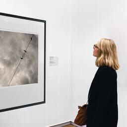 Art and collection photography Denis Olivier, Sky Line, Pyrénées, France. August 1990. Ref-929 - Denis Olivier Art Photography, A woman contemplate a large original photographic art print in limited edition and signed in a black frame