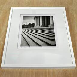 Art and collection photography Denis Olivier, South Entry, Cour Du Dôme Des Invalides, Paris, France. February 2023. Ref-11677 - Denis Olivier Art Photography, white frame on a wooden table
