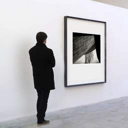 Art and collection photography Denis Olivier, Sports Arena, Etude 1, Saint-Nazaire, France. November 2022. Ref-11619 - Denis Olivier Art Photography, A visitor contemplate a large original photographic art print in limited edition and signed in a black frame
