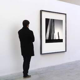 Art and collection photography Denis Olivier, Statue And Eiffel Tower, Trocadero, Paris, France. February 2022. Ref-11531 - Denis Olivier Art Photography, A visitor contemplate a large original photographic art print in limited edition and signed in a black frame