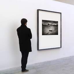 Art and collection photography Denis Olivier, Stranded Driftwoods, Pointe De La Coubre, France. June 2020. Ref-1347 - Denis Olivier Art Photography, A visitor contemplate a large original photographic art print in limited edition and signed in a black frame