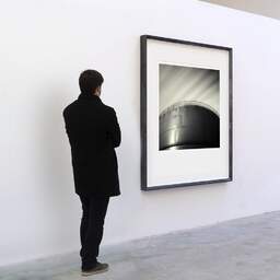 Art and collection photography Denis Olivier, Strorage Tank, Bassens Harbour, France. August 2006. Ref-1017 - Denis Olivier Art Photography, A visitor contemplate a large original photographic art print in limited edition and signed in a black frame