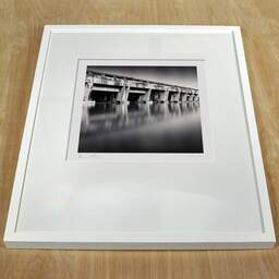 Art and collection photography Denis Olivier, Submarine Base, Etude 1, Bordeaux, France. August 2020. Ref-1416 - Denis Olivier Photography, white frame on a wooden table
