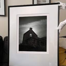 Art and collection photography Denis Olivier, Sun Behind The Window, Edinburgh Castle, Scotland. August 2022. Ref-11647 - Denis Olivier Photography, large original 9 x 9 inches fine-art photograph print in limited edition and signed hold by a galerist woman