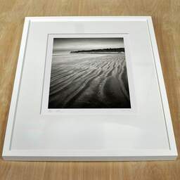 Art and collection photography Denis Olivier, Suzac Beach, Meschers-sur-Gironde, France. February 2023. Ref-11668 - Denis Olivier Photography, white frame on a wooden table