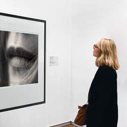 Art and collection photography Denis Olivier, Sweet On Her Lips, Bordeaux, France. April 2005. Ref-580 - Denis Olivier Art Photography, A woman contemplate a large original photographic art print in limited edition and signed in a black frame