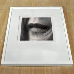 Art and collection photography Denis Olivier, Sweet On Her Lips, Bordeaux, France. April 2005. Ref-580 - Denis Olivier Photography, white frame on a wooden table