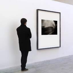 Art and collection photography Denis Olivier, TGV, Paris-Bordeaux, France. September 2020. Ref-1389 - Denis Olivier Art Photography, A visitor contemplate a large original photographic art print in limited edition and signed in a black frame