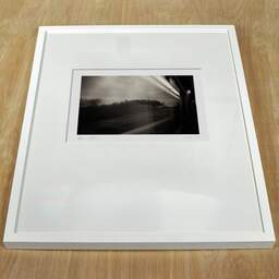 Art and collection photography Denis Olivier, TGV, Paris-Bordeaux, France. September 2020. Ref-1389 - Denis Olivier Photography, white frame on a wooden table