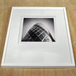 Art and collection photography Denis Olivier, The Gherkin, Etude 1, The City, London, England. April 2014. Ref-11459 - Denis Olivier Photography, white frame on a wooden table