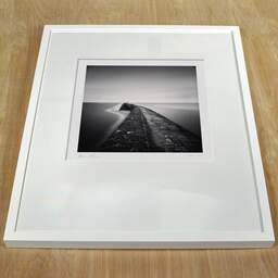 Art and collection photography Denis Olivier, Tréhic Pier, Etude 2, Le Croisic, France. May 2021. Ref-11470 - Denis Olivier Art Photography, white frame on a wooden table