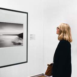 Art and collection photography Denis Olivier, Tréhic Pier, Etude 4, Le Croisic, France. May 2021. Ref-11680 - Denis Olivier Art Photography, A woman contemplate a large original photographic art print in limited edition and signed in a black frame