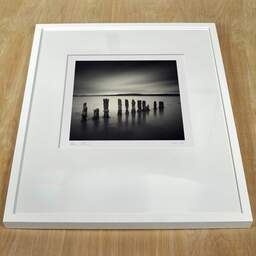 Art and collection photography Denis Olivier, Twelve Poles, Bunchrew House, Beauly Firth, Scotland. April 2006. Ref-956 - Denis Olivier Photography, white frame on a wooden table