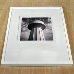 Art and collection photography Denis Olivier, Water Tower, Haut-Brion, Pessac, France. October 2022. Ref-11598 - Denis Olivier Art Photography, white frame on a wooden table