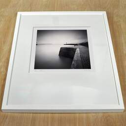Art and collection photography Denis Olivier, West Jetty, Etude 1, Sant-Nazaire, France. November 2021. Ref-11545 - Denis Olivier Photography, white frame on a wooden table
