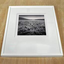 Art and collection photography Denis Olivier, Wet Fields, Aydat, Puy-de-Dôme, Auvergne, France. December 2021. Ref-11521 - Denis Olivier Photography, white frame on a wooden table